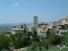 The belltower of St Clare's looking over the hills of Umbria